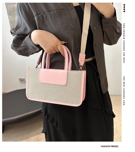 Pink leather and white canvas tote bag detail featuring the wide shoulder strap and flap