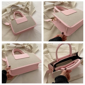Detail view of pink leather and beige canvas tote with wide adjustable strap