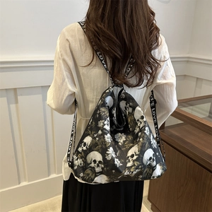 Black nylon tote bag with skull flower print and LOVE letter straps in a modern setting
