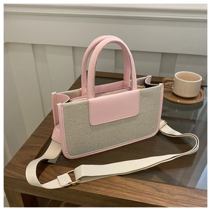 Detailed view of the pink and beige tote bag with canvas stitching and fabric shoulder strap