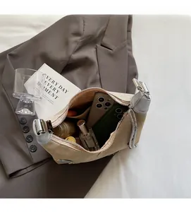 Macro view of beige canvas shoulder bag interior with daily essentials and compartments