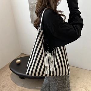 Minimalist black and white striped canvas tote bag with white lace bow detail