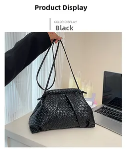 Close-up of black woven cloud bag showing intricate texture and metal frame closure