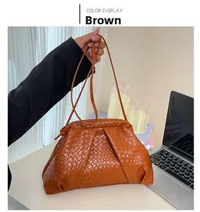 Close-up of brown woven PU leather cloud bag with intricate cross-weave craftsmanship