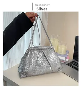 Silver woven faux leather dumpling bag detail with metallic finish and thin shoulder strap