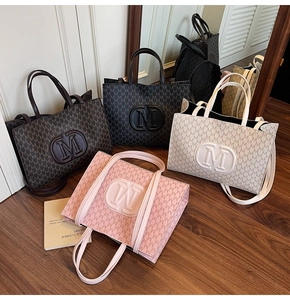 Detail showing high-capacity monogram tote bags in pink, brown, black and beige colors