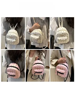 Detail shots of mini backpacks with black bow prints in white and pink leather colors