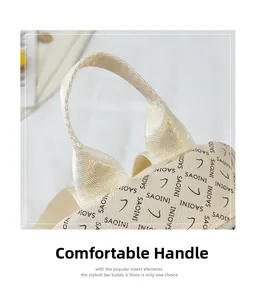 Détail de la poignée tissée confortable et de la texture en cuir grainé du sac à dos