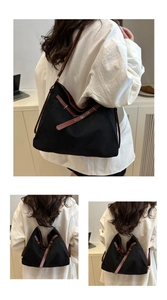 Détail du grand sac cabas en nylon noir avec bandoulières en cuir et boucles en métal