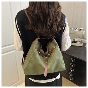 Detailed back view of an olive green matte backpack with brown leather straps and gold buckles