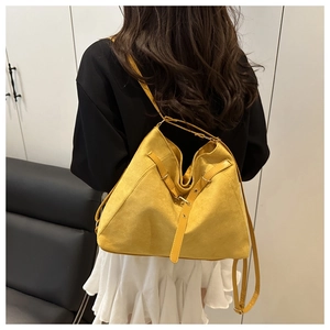 Rear view of large yellow suede tote bag with leather strap and metal buckle details