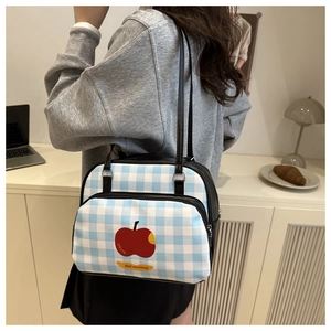 Blue and white checkered tote bag with a red apple print shown in a lifestyle setting