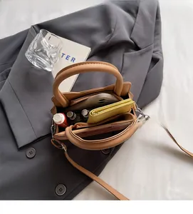 Brown leather handbag interior showing large capacity for phone, wallet and cosmetics