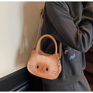 Model wearing a cat-shaped toast cross-body bag made of gradient faux leather