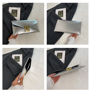 Detail view of silver rectangular clutch with metallic finish and gold geometric clasp