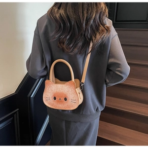 Detailed view of creative cat toast shaped crossbody bag worn by a model on stairs
