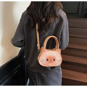 Detail of cute cat-shaped crossbody bag with 3D ears and whiskers on a model