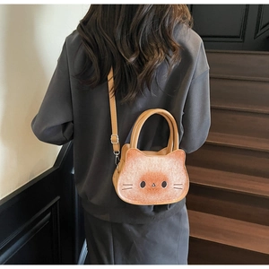 Cat-shaped crossbody bag shown on a model, featuring a unique toasted bread texture and color
