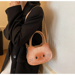 Close-up of a creative cat-shaped toast print handbag styled with a black blazer