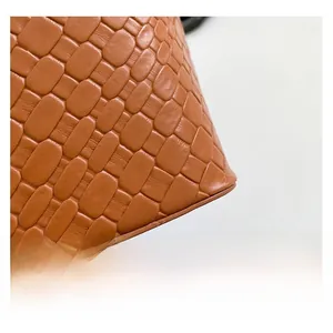 Close-up of the vintage brown shoulder bag showing woven leather texture and fine details