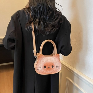 Cute brown cat-shaped crossbody handbag with 3D ears shown as a stylish shoulder bag