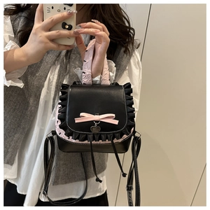 Detailed shot of Lolita style bag featuring black lace trim and a pink leather bow