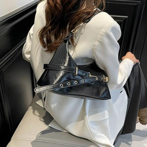 Chic black patent leather underarm bag with geometric shape and gold buckle hardware