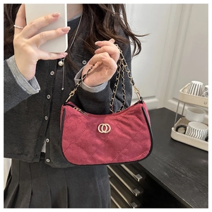 Chic burgundy quilted suede shoulder bag with gold hardware shown in a lifestyle mirror selfie