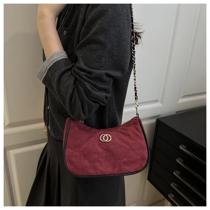 Burgundy suede shoulder bag with gold double-ring hardware and metal chain strap detail
