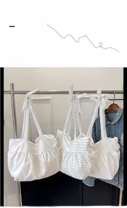 Detailed ruffled tote bags in white and polka dot patterns with bow tie handles