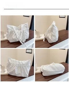 Multiple views of a pleated white bag with black polka dots and shoulder knot detail