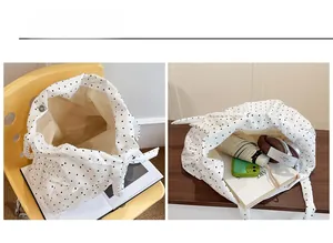 Internal view showing large capacity and magnetic closure of white polka dot tote bag
