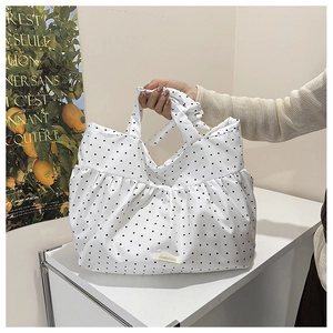 Detail of white polka dot tote bag with pleated ruffles and large capacity design