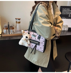 Detailed view of pink polka dot shoulder bag with cute white plush bear charm and bow