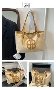 Detail of khaki brown large tote bag with circular cutout logo and leather handles