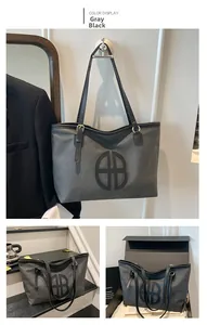 Detail view of large grey-black tote bag with double B logo on a hanging display