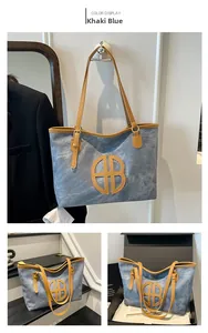 Detail view of khaki blue tote bag with contrast brown leather trim and circular logo
