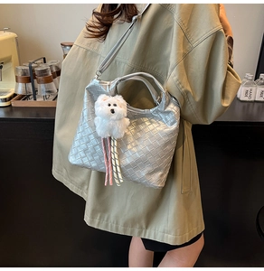 Silver woven bucket bag with metallic texture, long strap and cute plush dog charm