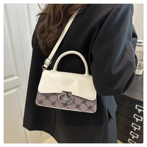 Detail of vintage crossbody bag with white flap and purple monogram pattern texture