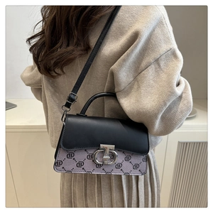 Detail view of a vintage small square handbag with contrast colors and silver buckle