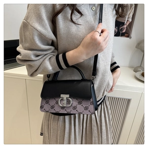 Detail of vintage flap crossbody bag with silver hardware on model in beige outfit