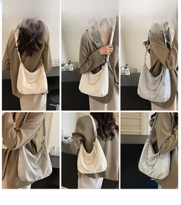 Detail view of large capacity ruched shoulder bags in cream and silver with metal chain