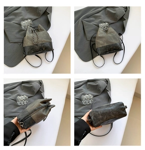 Detail view of retro bucket bag in grey canvas and black leather with silver chain