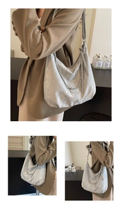Detail of silver metallic hobo bag with pleated texture and chunky chain strap