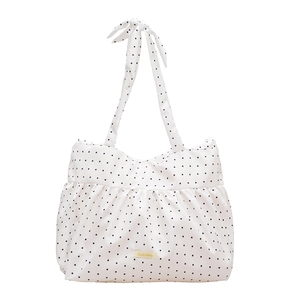 White polka dot tote bag with large bow shoulder strap and ruffled texture design