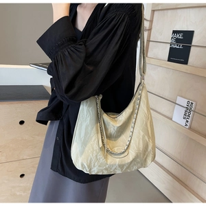 Detail of hobo bag with marble texture pleated fabric and silver chain strap decoration