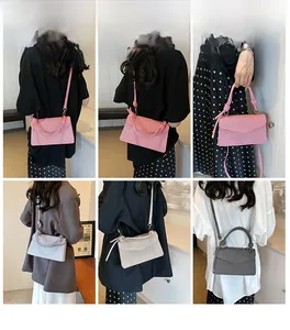 Detail view of woven texture envelope bags in pink, grey, and black with knotted handles