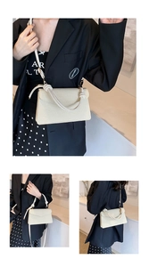 Detail view of cream square bag with woven texture and unique knotted rope handle