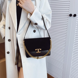 Retro black leather shoulder bag with gold metal logo and chain strap on model