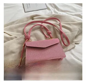 Detail view of the pink striped fabric crossbody bag with a decorative knotted handle